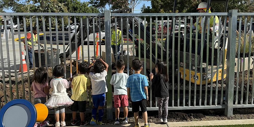 Children watching landscape installation.