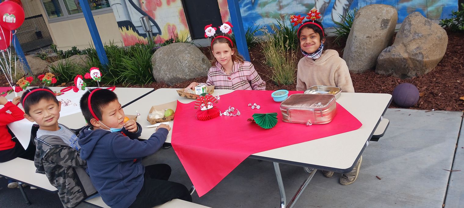 students at holiday decorated table