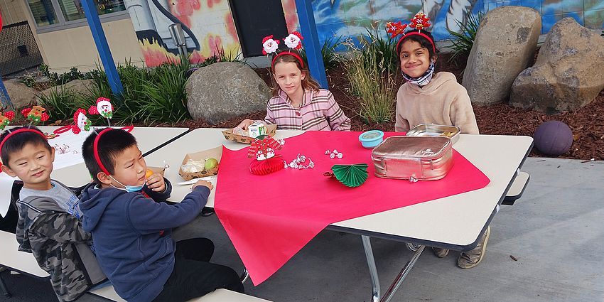 students at holiday decorated table