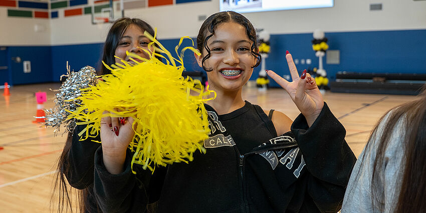 Sherman Oaks student with pompom at the ribbon cutting for the gym.