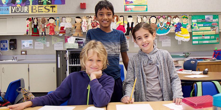 three students smiling