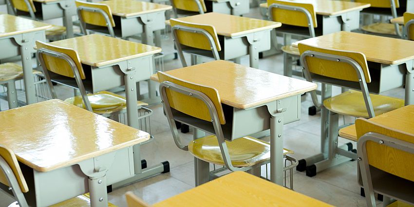 empty classroom desks in rows
