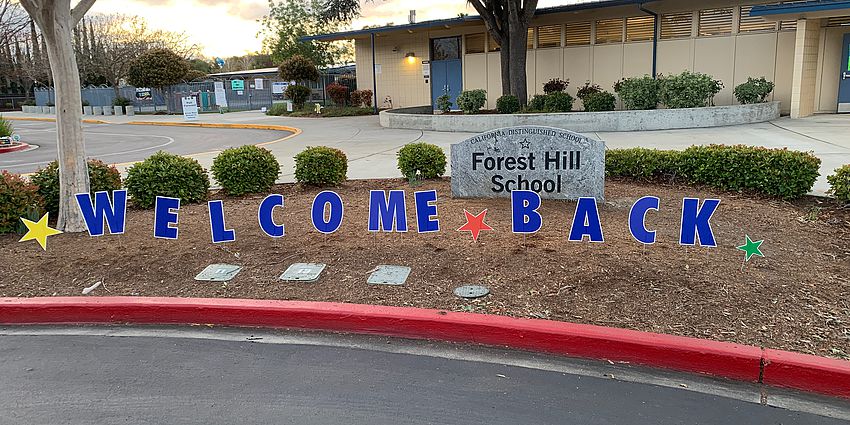 Welcome back sign in front of Forest Hill School