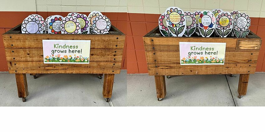 Planter boxes with paper flowers decorated with kindness pledges
