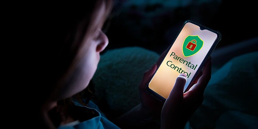 young child looking at cell phone and screen says Parental Control