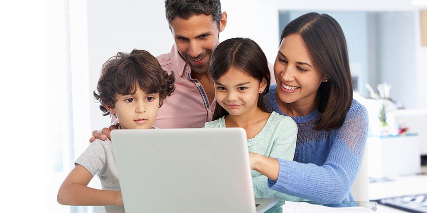 family using a laptop
