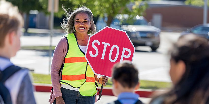 smiling woman crossing guard