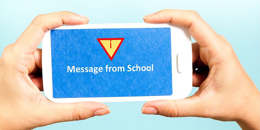 A cellphone with the following message: Message from School