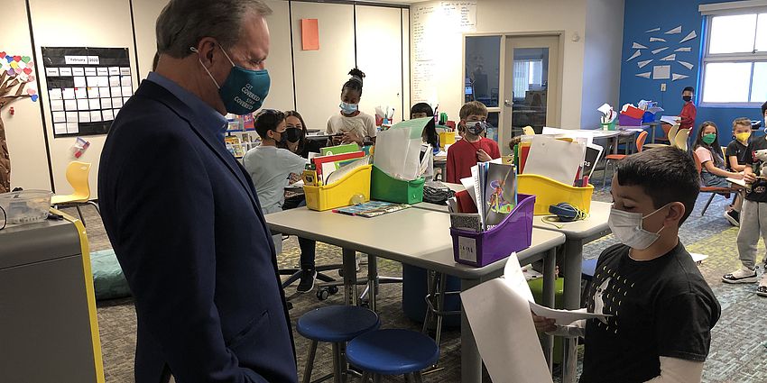 Senator listens as boy reads a letter to him