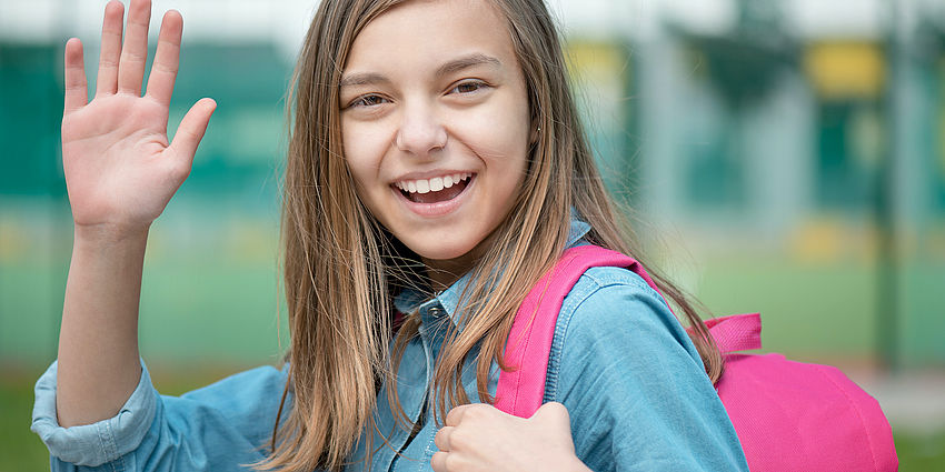 A student waving