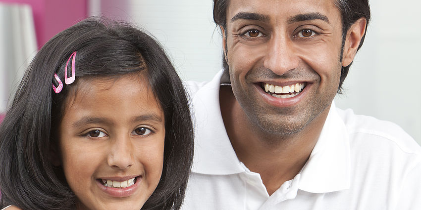 father and daughter using laptop together