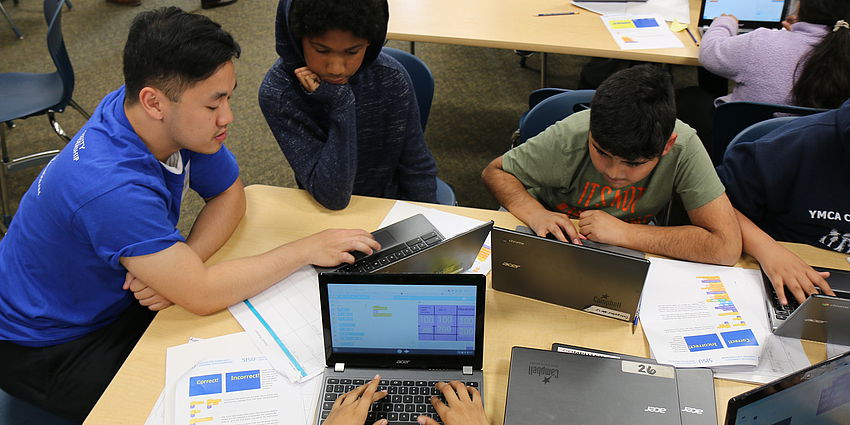 students learn coding with help from college student