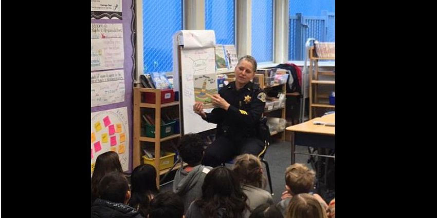 police officer reading to a class