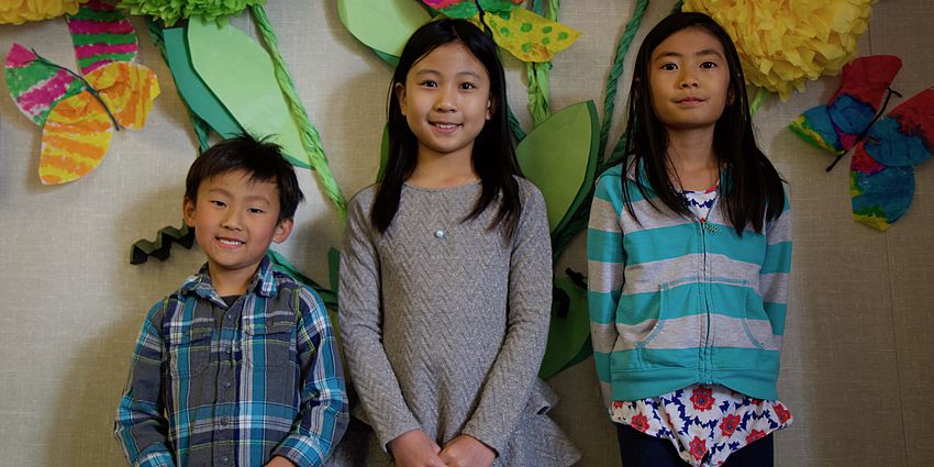 three students smiling