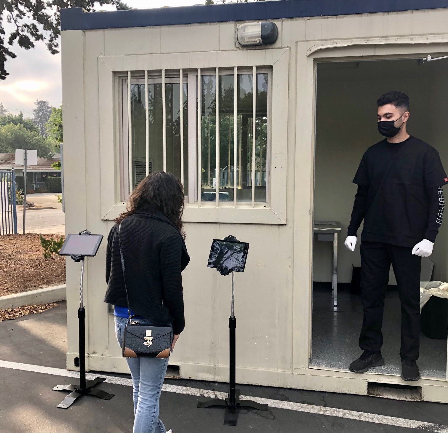 2 people standing at the COVID testing booth
