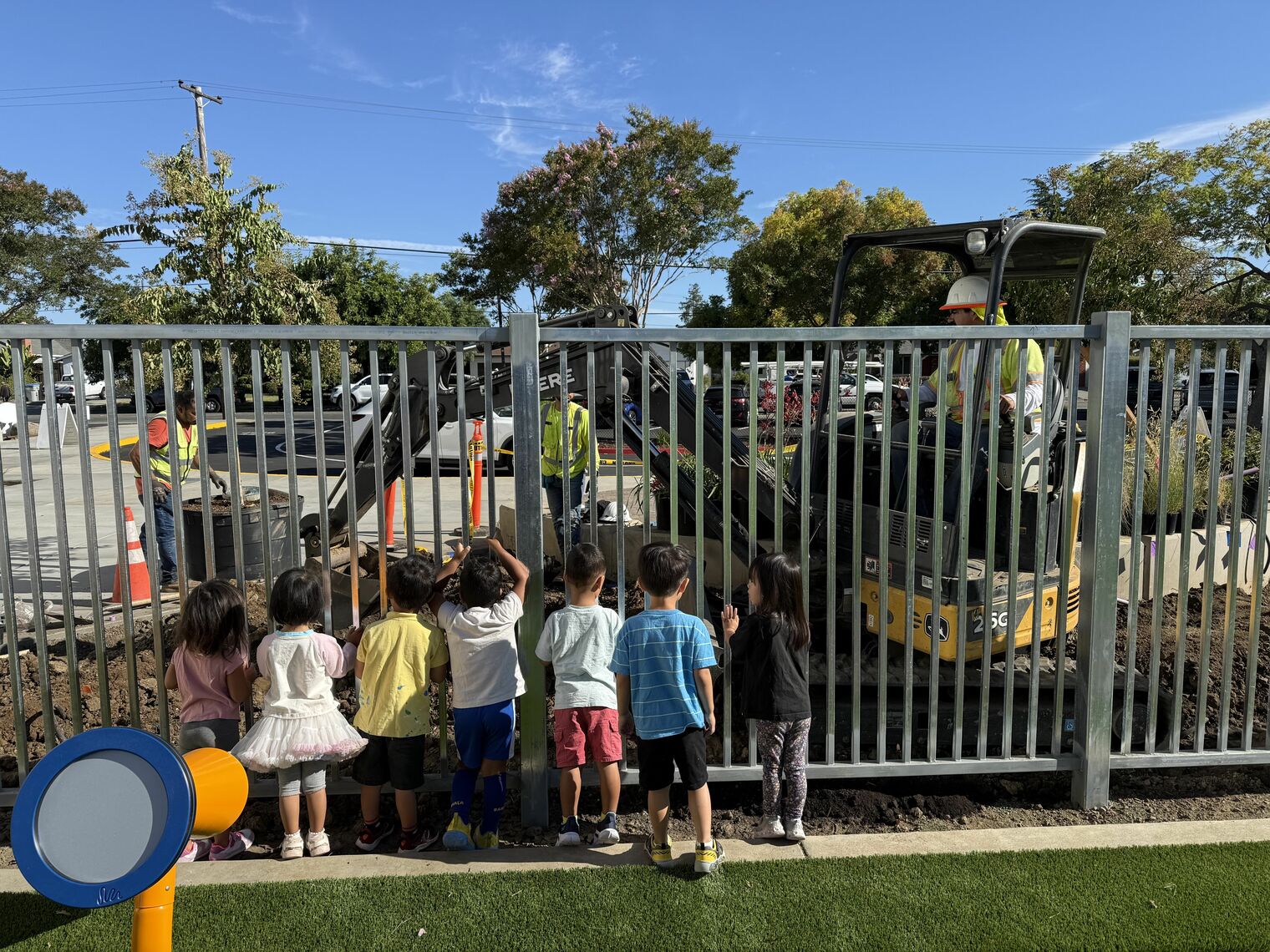 Children watching landscape installation.