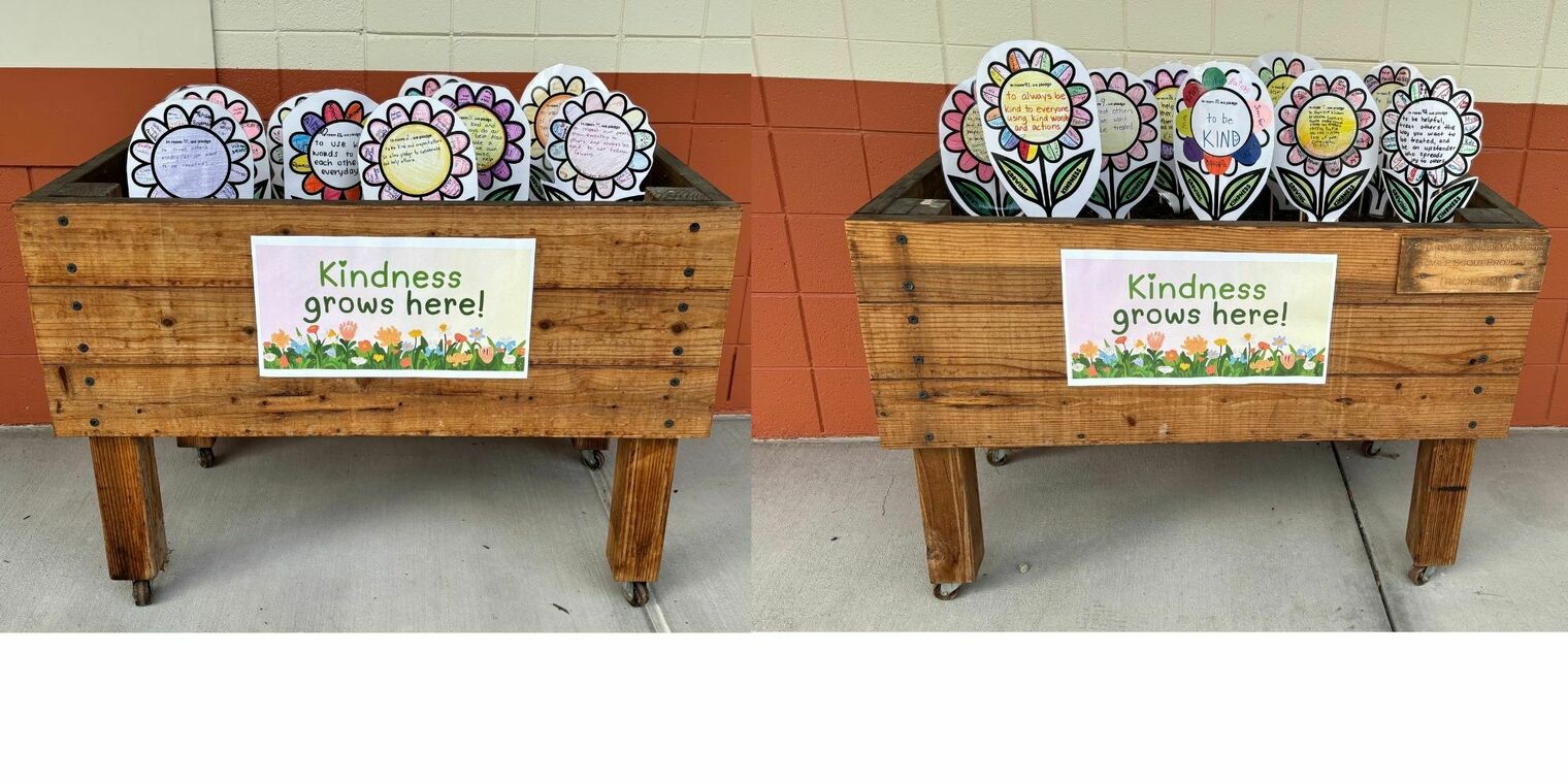 Planter boxes with paper flowers decorated with kindness pledges
