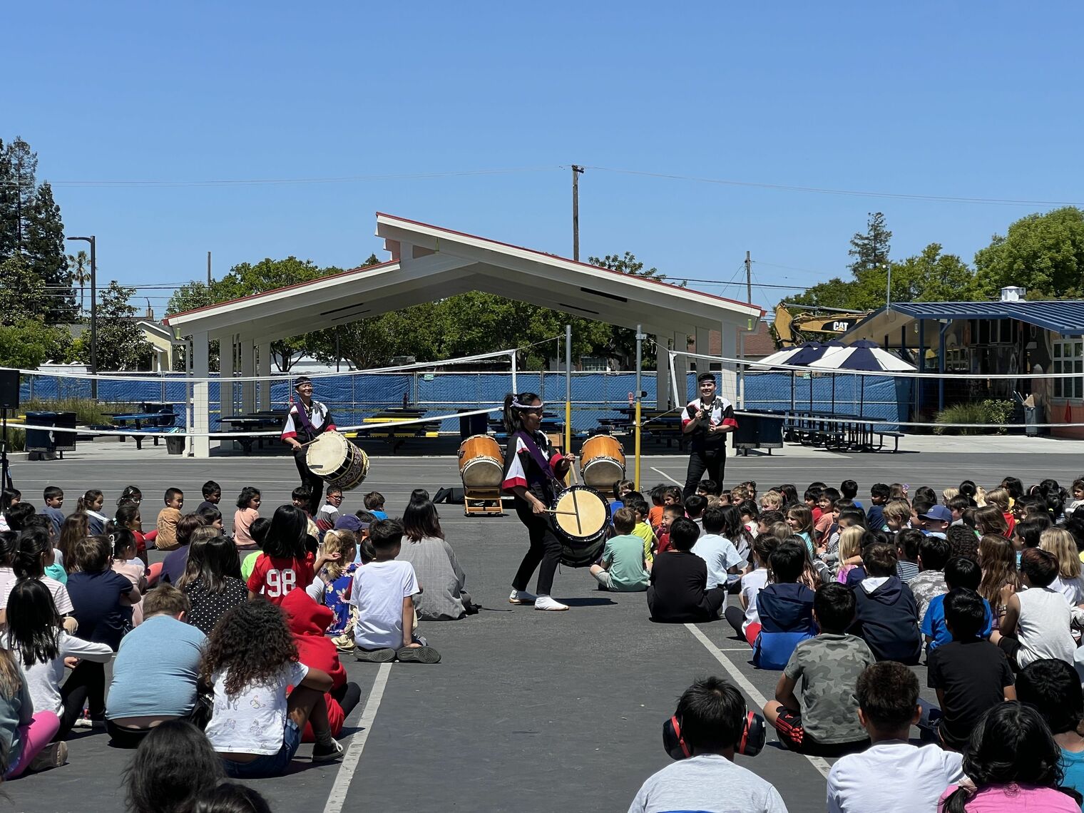 Taiko drummers perform at an assembly